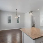 Photo of an entry way, family room, and bathroom.