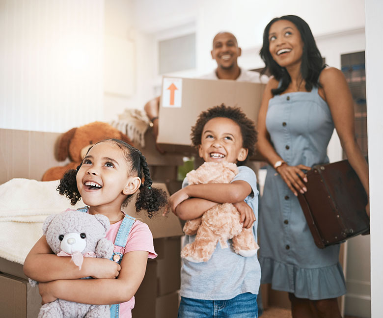 Photo of young family moving into a house.