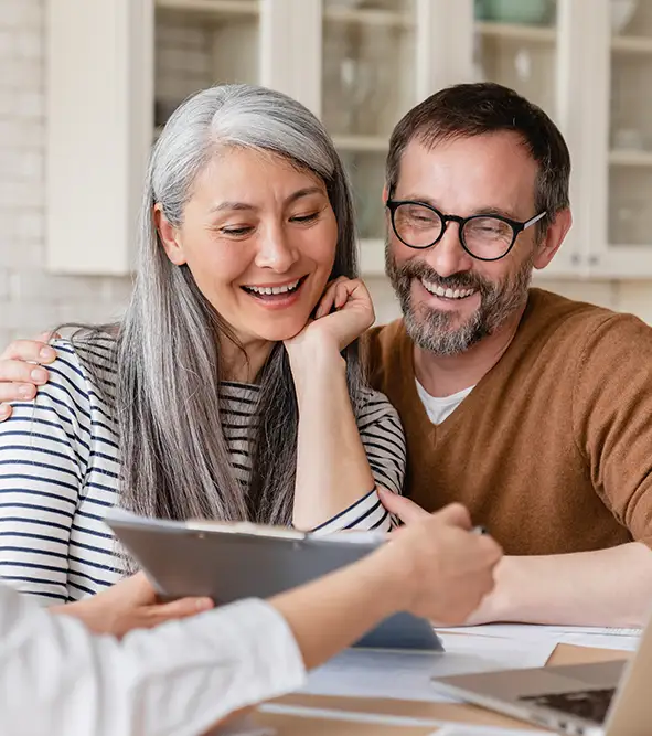 Photo of happy couple reviewing house information.